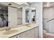 Bright bathroom featuring a double vanity and a walk-in shower at 14950 Gulf Blvd # 404, Madeira Beach, FL 33708