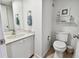 Cozy bathroom featuring a single vanity, toilet, and nautical decor at 14950 Gulf Blvd # 404, Madeira Beach, FL 33708