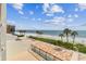 Expansive beach view from the private patio featuring palm trees and blue skies at 14950 Gulf Blvd # 404, Madeira Beach, FL 33708