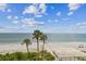 Breathtaking beach view from the condo featuring palm trees, sand, and blue ocean at 14950 Gulf Blvd # 404, Madeira Beach, FL 33708