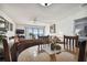 Dining room features a wood table and chairs, flowing to the living area with ocean views at 14950 Gulf Blvd # 404, Madeira Beach, FL 33708