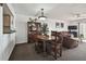 Dining room flows into living area and features a wooden table and chairs at 14950 Gulf Blvd # 404, Madeira Beach, FL 33708