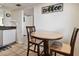 Eat-in kitchen area features a table with seating for 2 and decorative coffee wall decor at 14950 Gulf Blvd # 404, Madeira Beach, FL 33708