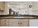Kitchen has granite counters, cabinets and a view into the living area at 14950 Gulf Blvd # 404, Madeira Beach, FL 33708