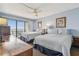 Bright bedroom with two beds, ocean view balcony, and light blue walls at 14950 Gulf Blvd # 404, Madeira Beach, FL 33708