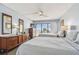 Comfortable bedroom showcasing beds, dressers, mirrors, and direct balcony access with ocean views at 14950 Gulf Blvd # 404, Madeira Beach, FL 33708