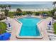 Beautiful geometric pool with gulf views, surrounded by lounge chairs and a nearby spa at 14950 Gulf Blvd # 404, Madeira Beach, FL 33708