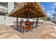 Tiki bar offers a tropical spot to unwind, with seating, counter space and a thatched roof at 14950 Gulf Blvd # 404, Madeira Beach, FL 33708