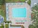 Community pool with patio and lounge chairs at 3300 Fox Chase N Cir # 231, Palm Harbor, FL 34683