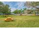 Community playground with swings, slides, and picnic tables at 3300 Fox Chase N Cir # 231, Palm Harbor, FL 34683