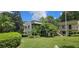 Two-story condo building with lush landscaping and parking at 3300 Fox Chase N Cir # 231, Palm Harbor, FL 34683