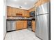 Modern kitchen with stainless steel appliances and wood cabinets at 3300 Fox Chase N Cir # 231, Palm Harbor, FL 34683