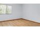Bright bedroom with wood-look floors and window with blinds at 3300 Fox Chase N Cir # 231, Palm Harbor, FL 34683