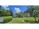 Two-story condo building with lush landscaping and parking at 3300 Fox Chase N Cir # 231, Palm Harbor, FL 34683
