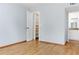 Bright bedroom with wood-look floors, mirrored closet, and access to a bathroom at 3300 Fox Chase N Cir # 231, Palm Harbor, FL 34683