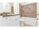 Bathroom with granite countertop, white cabinets, and shower/tub combo at 3300 Fox Chase N Cir # 231, Palm Harbor, FL 34683