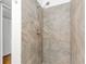 Shower with beige tile surround and handheld shower head at 3300 Fox Chase N Cir # 231, Palm Harbor, FL 34683