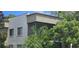 Exterior view of a condo building with balconies and lush tropical landscaping at 3300 Fox Chase N Cir # 231, Palm Harbor, FL 34683