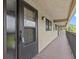 Hallway with access to condo unit, featuring neutral walls at 1933 Golfview Dr # 1933, Tarpon Springs, FL 34689