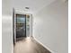 Bright hallway with wood-look flooring and access to balcony at 1933 Golfview Dr # 1933, Tarpon Springs, FL 34689