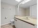 Bathroom with single vanity, toilet and neutral-toned tile at 1933 Golfview Dr # 1933, Tarpon Springs, FL 34689