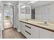 Bathroom with double vanity, neutral tones, and wood-grained cabinets at 1933 Golfview Dr # 1933, Tarpon Springs, FL 34689
