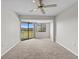Spacious bedroom with a large window offering a golf course view and a ceiling fan at 1933 Golfview Dr # 1933, Tarpon Springs, FL 34689