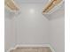 Walk-in closet with wire shelving for ample storage at 1933 Golfview Dr # 1933, Tarpon Springs, FL 34689