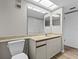 Bathroom with single vanity, toilet and view to closet at 1933 Golfview Dr # 1933, Tarpon Springs, FL 34689