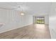 Spacious living room with wood-look floors and sliding glass doors at 1933 Golfview Dr # 1933, Tarpon Springs, FL 34689