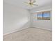 Bright bedroom with ceiling fan, neutral walls, and plush carpeting at 1933 Golfview Dr # 1933, Tarpon Springs, FL 34689