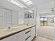 Bathroom with double vanity, neutral tones, and view to living room at 1933 Golfview Dr # 1933, Tarpon Springs, FL 34689