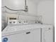 Laundry room with side-by-side Maytag washer and dryer at 1933 Golfview Dr # 1933, Tarpon Springs, FL 34689