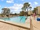 Relaxing community pool area with surrounding patio at 1933 Golfview Dr # 1933, Tarpon Springs, FL 34689