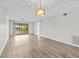 Spacious living room with wood-look floors and sliding glass doors at 1933 Golfview Dr # 1933, Tarpon Springs, FL 34689