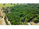 Aerial view of a property with a small house and a dense forest at 6191 Lockhart Rd, Brooksville, FL 34602
