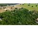 Aerial view of a property surrounded by lush greenery and nearby roads at 6191 Lockhart Rd, Brooksville, FL 34602
