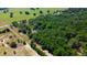 Aerial view showing a property with houses and a large forest at 6191 Lockhart Rd, Brooksville, FL 34602