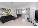 Bright living room with tile floors and a large TV at 219 6Th Sw Ave, Largo, FL 33770