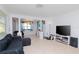 Bright living room with tile floors and a large TV at 219 6Th Sw Ave, Largo, FL 33770