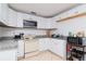 Efficient kitchen with white cabinets and granite counters at 219 6Th Sw Ave, Largo, FL 33770