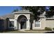 House entrance with arched entryway, double doors, and columns at 15151 Eastwood Trl, Brooksville, FL 34604