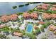 Stunning aerial view of a waterfront condo community featuring a tennis court and lush landscaping at 2732 Via Murano # 526, Clearwater, FL 33764