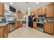 Bright kitchen featuring stainless steel appliances and wood cabinets at 448 Stone Briar Dr, Ruskin, FL 33570