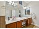 Double vanity bathroom with a large mirror and tile flooring at 448 Stone Briar Dr, Ruskin, FL 33570