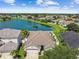 Aerial view of house near lake, community, and other homes at 448 Stone Briar Dr, Ruskin, FL 33570