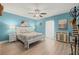 Bright bedroom with ceiling fan and light wood flooring at 8911 Blind Pass Rd # 305, St Pete Beach, FL 33706