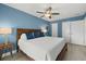 Serene main bedroom with wood platform bed and blue walls at 8911 Blind Pass Rd # 305, St Pete Beach, FL 33706