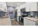 Modern kitchen with stainless steel appliances and granite counters at 8911 Blind Pass Rd # 305, St Pete Beach, FL 33706