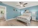 Bright bedroom with ceiling fan and light wood flooring at 8911 Blind Pass Rd # 305, St Pete Beach, FL 33706